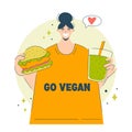 A happy woman chooses veganism and vegetables. Vegetarian delicious food concept girl eating yammy vegan burger and smoothie