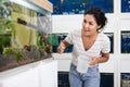 Woman choosing aquarium fish at pet shop Royalty Free Stock Photo