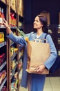 Happy woman choosing and buying food in market Royalty Free Stock Photo