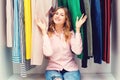 Happy woman choosing clothes at home wardrobe. Hard choice. Clothing, fashion, lifestyle and people concept. Women fashion shop. Royalty Free Stock Photo