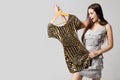 Happy Woman Choosing Dress, Attractive Girl Holding Gold Clothes on Hanger on White Royalty Free Stock Photo