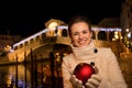 Happy woman with Christmas Ball near Rialto Bridge in Venice Royalty Free Stock Photo