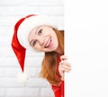 Happy woman at Christmas with blank empty white poster