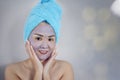 Happy woman with a clay mask. Photo of attractive young woman wi