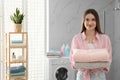 Happy woman with towels in bathroom. Laundry day Royalty Free Stock Photo