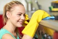 Happy woman cleaning cooker at home kitchen Royalty Free Stock Photo