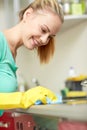 Happy woman cleaning cooker at home kitchen Royalty Free Stock Photo