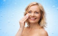 Happy woman cleaning face with cotton pad Royalty Free Stock Photo