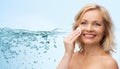 Happy woman cleaning face with cotton pad Royalty Free Stock Photo