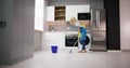 Happy Woman Cleaning Floor With Mop In Kitchen Royalty Free Stock Photo