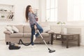 Happy woman cleaning home with vacuum cleaner Royalty Free Stock Photo