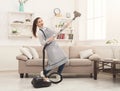 Happy woman cleaning home with vacuum cleaner Royalty Free Stock Photo