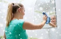 Happy woman cleaning mirror with rag Royalty Free Stock Photo