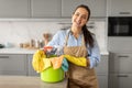 Happy woman with cleaning supplies in bucket Royalty Free Stock Photo