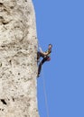 Happy woman climbing rock. Royalty Free Stock Photo