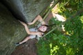 Happy woman climbing on a rocky wall rope, bouldering Royalty Free Stock Photo