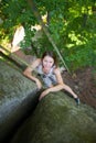 Happy woman climbing on a rocky wall rope, bouldering Royalty Free Stock Photo