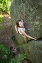 Happy woman climbing on a rocky wall rope, bouldering Royalty Free Stock Photo