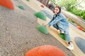 Woman climbing on a wall at urban children playground Royalty Free Stock Photo
