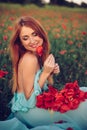 Happy woman with closed eyes holding bouquet of poppies Royalty Free Stock Photo