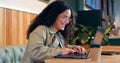 Happy woman in coffee shop, typing on computer and remote work, reading email or writing blog, article or search on Royalty Free Stock Photo