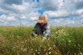 Happy woman collecting medicinal herbs