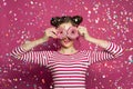 Happy woman in confetti on vivid pink background Royalty Free Stock Photo