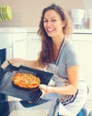 Happy woman cooking pizza at home Royalty Free Stock Photo