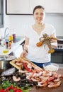 Happy woman cooking sea food specialties Royalty Free Stock Photo