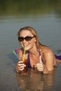 Happy woman with cool drink in the water Royalty Free Stock Photo