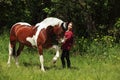 Happy woman cowgirl with her horse