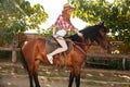 Happy woman cowgirl smiling and riding horse Royalty Free Stock Photo