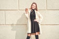 Happy woman with cup of coffee on a street