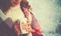 Happy woman with cup of hot drink on cold winter outdoors Royalty Free Stock Photo