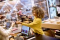 Happy woman customer paying with credit card in fashion showroom Royalty Free Stock Photo