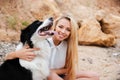Happy woman with cute dog on the beach in summer Royalty Free Stock Photo