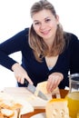 Happy woman cutting cheese