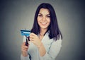 Happy woman cutting in half her credit card with scissors Royalty Free Stock Photo