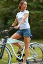 Happy Woman is Cycling in Summer Park Royalty Free Stock Photo