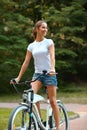 Happy Woman is Cycling in Summer Park Royalty Free Stock Photo