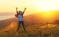 Happy woman dances, jump, rejoices, laughs on sunset in nature Royalty Free Stock Photo