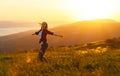 Happy woman dances, rejoices, laughs on sunset in nature Royalty Free Stock Photo