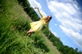 Happy woman dancing on the grass