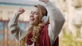 Happy woman dancing on headphones outside. Smiling girl listening music on phone Royalty Free Stock Photo