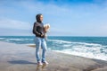 Woman with a doggie of in the early spring near the sea Royalty Free Stock Photo