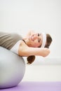 Happy woman doing abdominal crunch on fitness ball Royalty Free Stock Photo