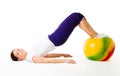 Happy woman doing fitness exercises with ball