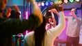 Happy woman doing karaoke at dance party Royalty Free Stock Photo