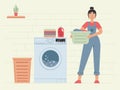 Happy woman doing laundry. Woman holding backet with clean clothes. Housework, laundry service. Washing clothes.