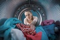 Woman loading the washing machine Royalty Free Stock Photo